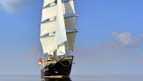 Sailing yacht RUNNING ON WAVES -  At Sea